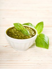 green pesto on a wooden background