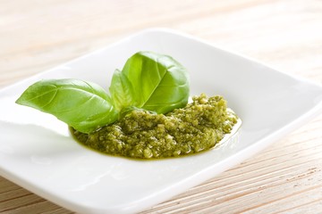 green pesto on a wooden background