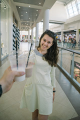 Woman Drinking Smoothie while walking the mall