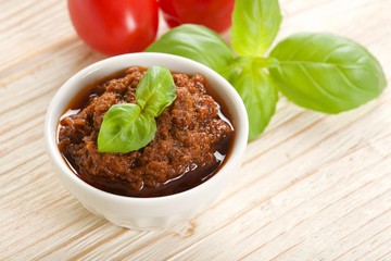 red pesto on a wooden background