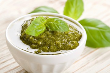 green pesto on a wooden background