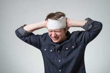 Man with bandage on his head