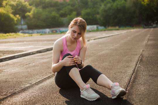 Sports Girl Clinging To Her Knee Due To Injury