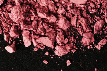 Broken pink blush on black table