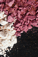 Naklejka premium Pink rose blush and white face powder lie broken on the table