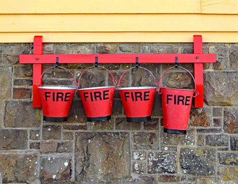 A row of 4 vintage fire buckets