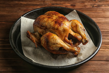 Homemade baked lemon chicken on wooden table