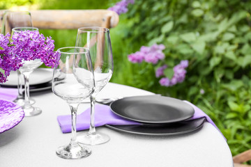 Beautiful table setting with lilac flowers decoration