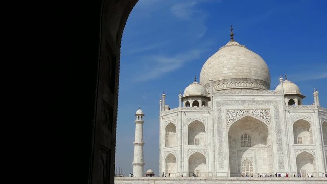 Taj Mahal dome and minarets on the background of blue sky; UNESCO World heritage site in Agra, India.