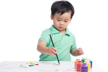 Portrait of cheerful asian boy painting using watercolors