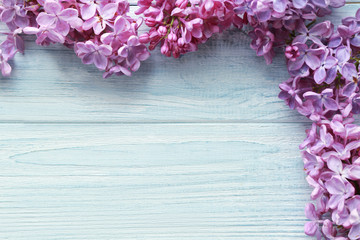 Beautiful lilac flowers on wooden background