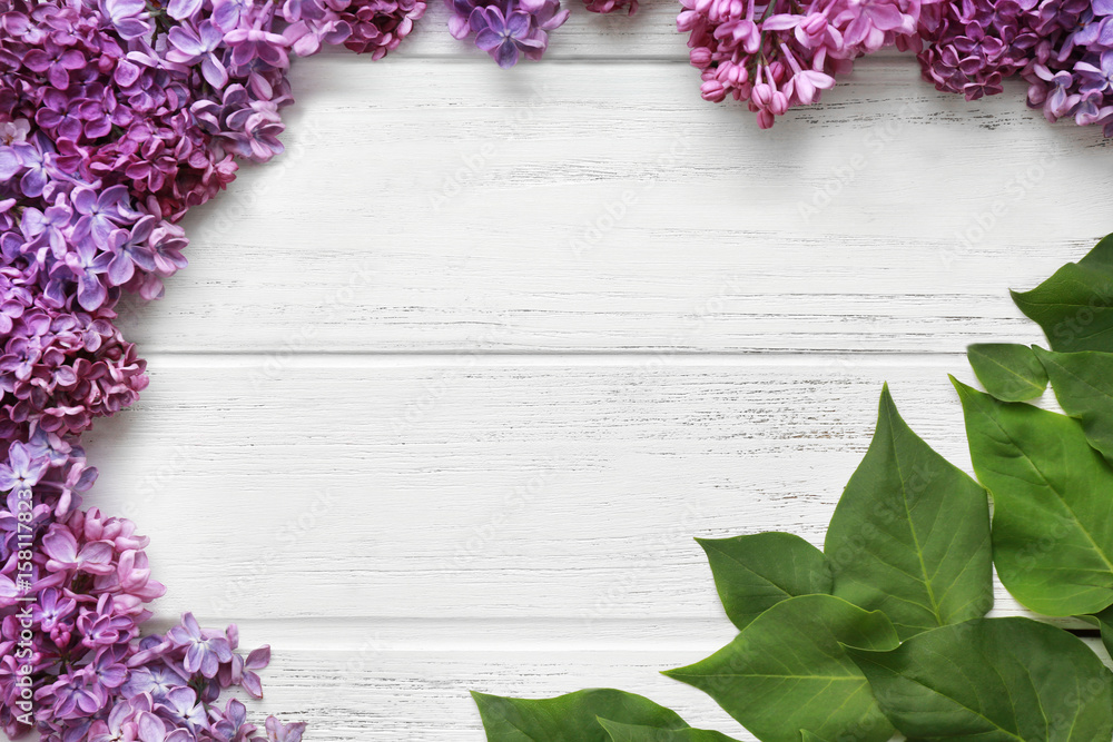 Wall mural beautiful lilac flowers on wooden background