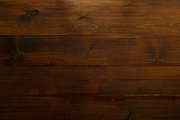 Obraz na płótnie Canvas Dark brown wooden background with horizontal planks