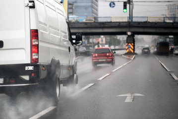 A vehicle moving fast on a highway in a city during heavy rain.