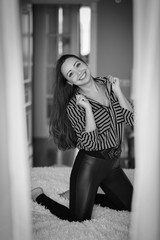 Beautiful brunette girl in seductive and flirting pose, a black and white frame