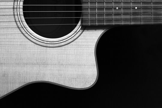 Guitar on black background, black and white photo