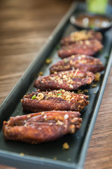 Deep fried chicken wing arrange over black dish