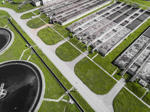 Sewage farm. Static aerial photo looking down onto the clarifying tanks and green grass. Geometric background texture.