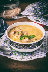 Soup with barley and chicken gizzards. Instagram style filtred image.