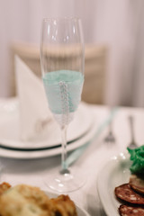 Champagne flute decorated with mint ribbon