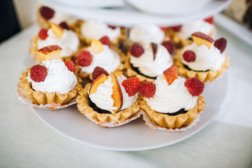 Cupcakes with white cream and berries