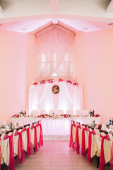 Pink ribbons hang from white chairs in the restaurant