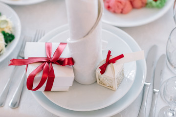 White box stands on the plate before a serviette