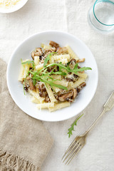 Italian pasta with mushrooms in white bowl