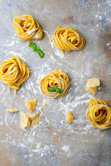 Homemade tagliatelle pasta nest, parmesan and basil