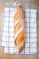 One fresh crunchy Baguette on slate