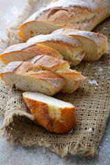 Sliced fresh Baguette on the sackcloth