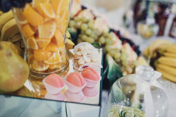 Bowls with fruits and dishes with pastry