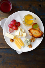 Assortment of sliced Cheeses on white plate
