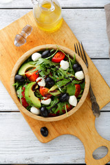 Fresh Avocado Salad with tomatoes, olive, mozzarella and arugula