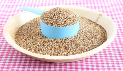 Healthy food kodo millet in a measuring cup.