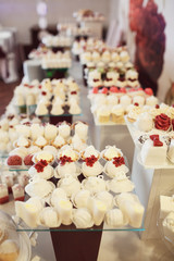 Cookies covered with red and white icing served on the table