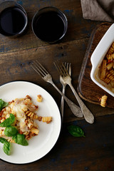 Pasta with Bolognese sauce and wine on old wooden table