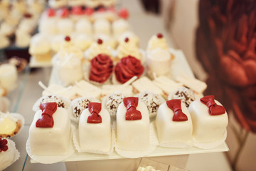 Cookies covered with red and white icing served on the table