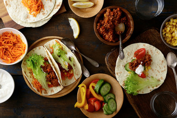 Mexican Tacos with ground beef and pork, carrots, cucumber, corn, pepper, tomato, lettuce