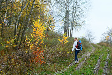 Woman hiker walking on the autumn nature