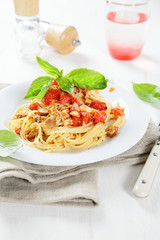 Spaghetti with mushrooms and tomato on a plate