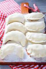Fototapeta na wymiar Homemade raw dumplings on the cutting board