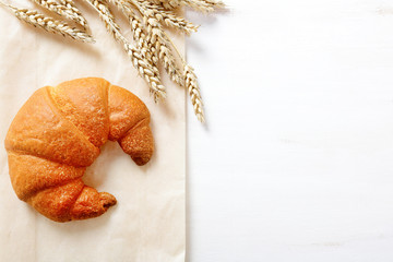 Tasty French croissants with ears of wheat