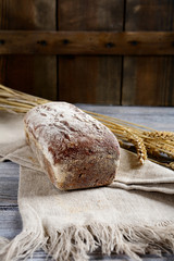 Black Bread and burlap on a wooden background