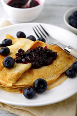 Delicious crepes with jam on a plate