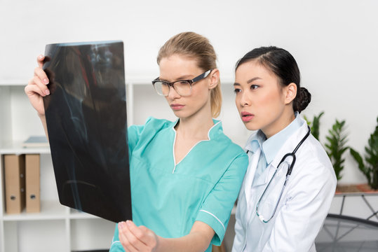 portrait of focused doctors looking at x-ray picture together at hospital
