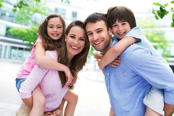 Family smiling together outdoors
