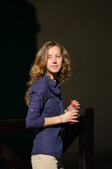 Young blonde woman with a jar smoothie in her hands