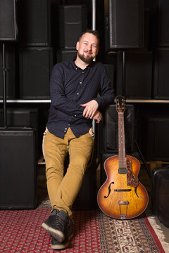Guitarist sitting on guitar combo