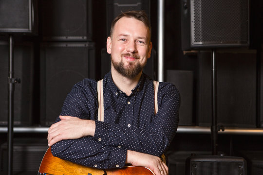 Guitarist sitting on guitar combo